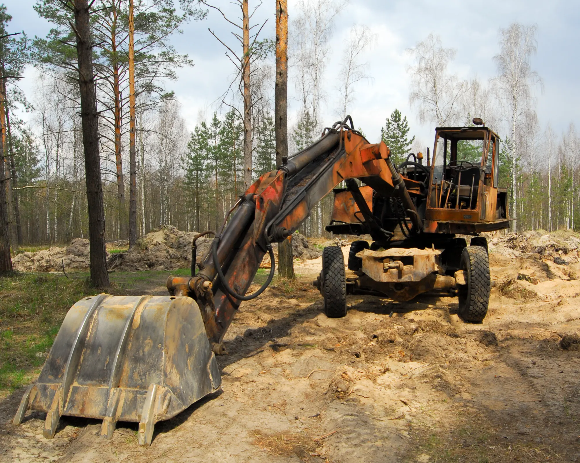 Excavator working on stump removal