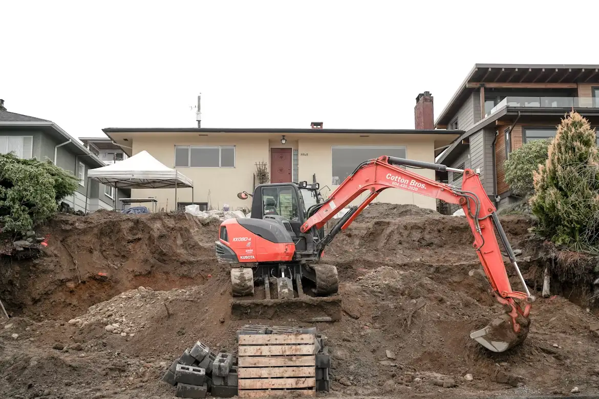 Mini excavator performing grading work